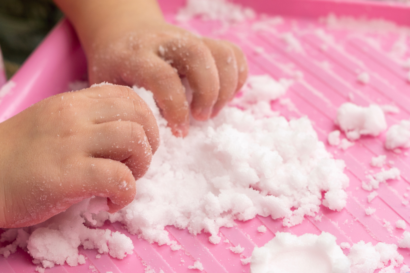 Child plays with artificial snow