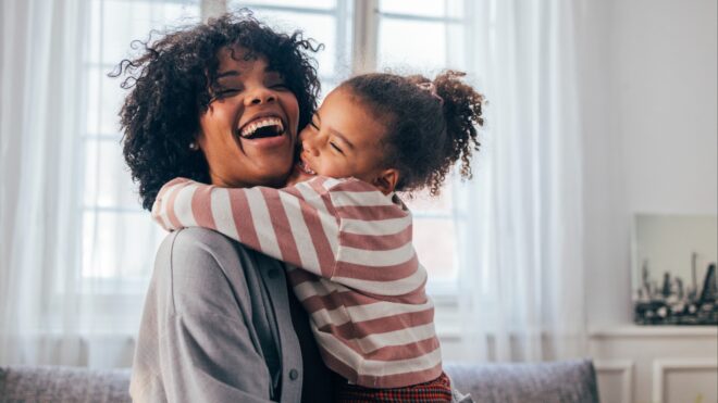 A mom hugging her daughter