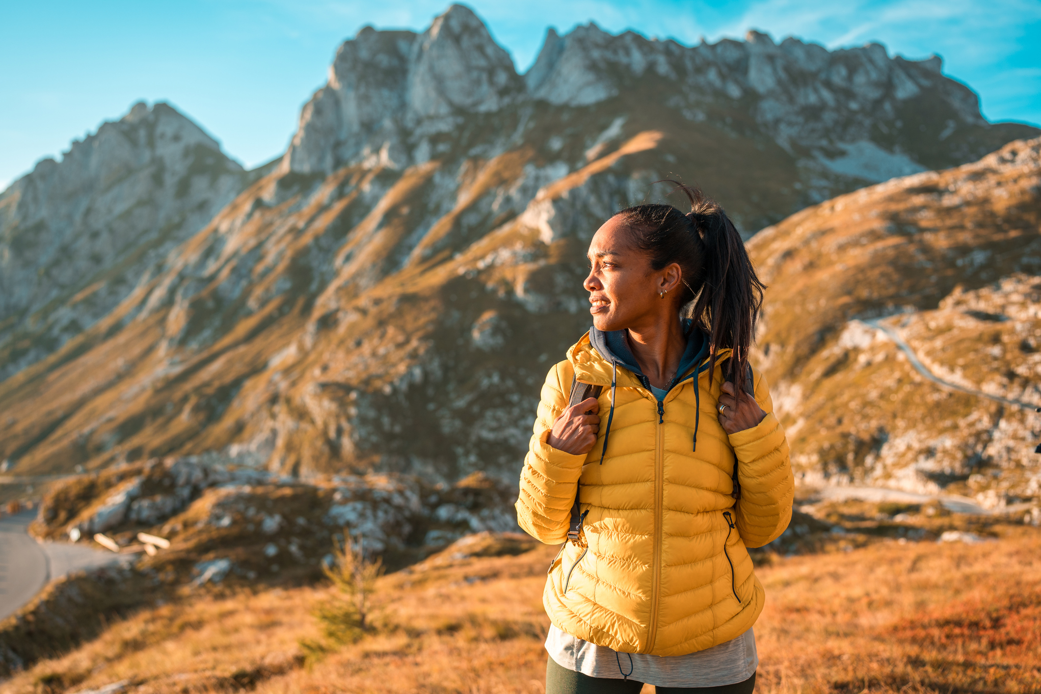 Mid Adult Hispanic Female in Yellow Jacket Hiking in Landscape