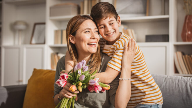 Son giving mom flowers