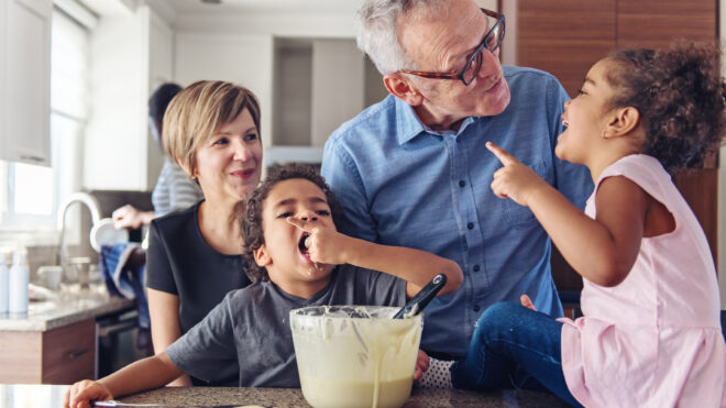 Grandparents making cupcake with kids