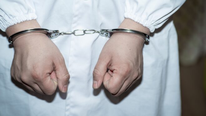 person in handcuffs