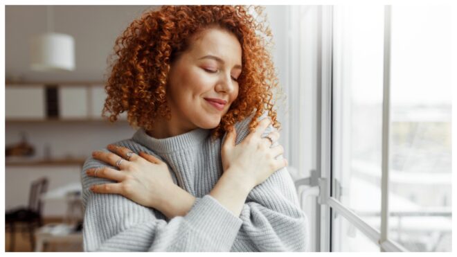 Woman hugging herself