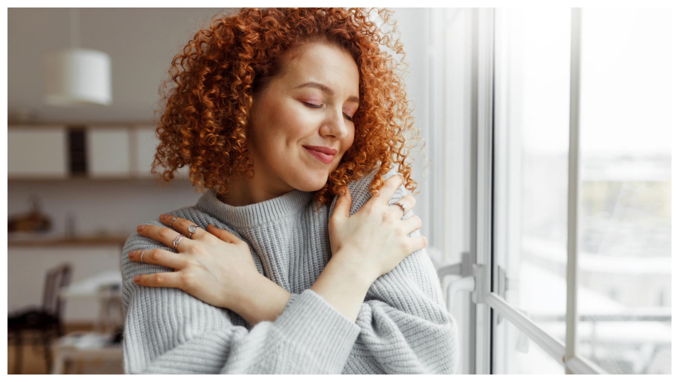 Woman hugging herself