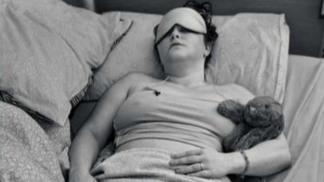 Kelly Smith-May laying in bed with long covid